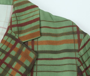 Detailed close-up showing the plaid fabric texture and neckline of the checkered blazer