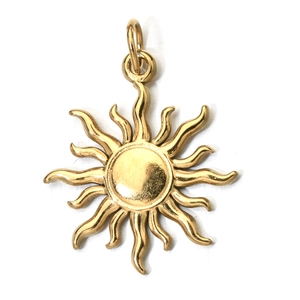 Close-up of a golden sun pendant with wavy rays on a clean white background