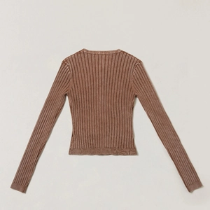 Detail view of the ribbed texture and back design of a brown vintage knitted cardigan