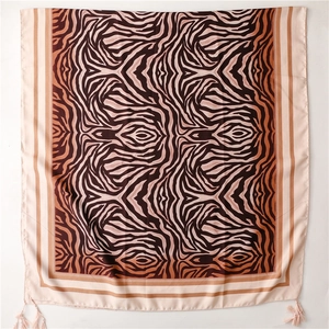 Detail of zebra print silk shawl showing brown pink stripes and corner tassels
