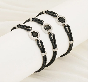 Detail of nautical braided leather bracelets with anchor and compass charms