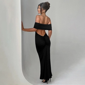Detail of the elegant backless design and ruching on this slim fit black evening maxi dress