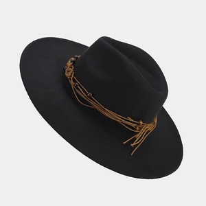 Detail of black wool fedora hat with brown braided tassels and decorative beads
