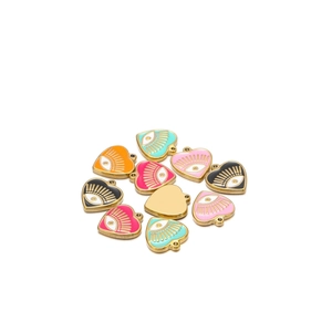 Detailed view of colorful heart-shaped evil eye pendants with gold-plated metal borders