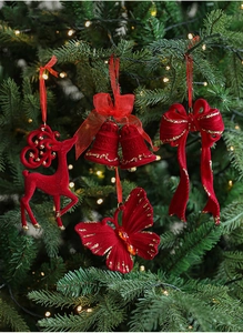 Detail of red flocked Christmas pendants with gold glitter on a green festive tree branch