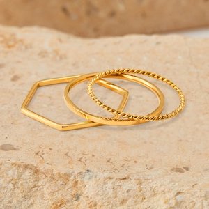 Three-piece stackable gold stainless steel ring set with geometric and braided textures