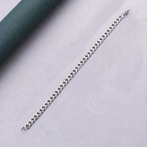 Close-up of polished silver Cuban link chain bracelet with a classic hip hop aesthetic