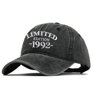 Detail of washed grey baseball cap featuring white Limited Edition 1992 embroidery