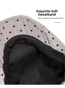 Detailed macro view showing the soft black cotton sweatband and gray heart pattern fabric
