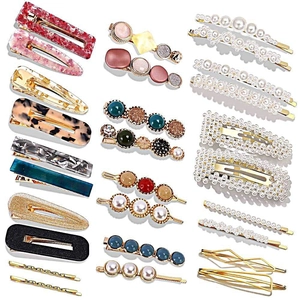 Macro shot of assorted hair clips set featuring pearls, acrylic textures and colorful rhinestones