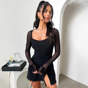 Detail of sheer mesh long sleeves with bow ribbons and thumbhole cuffs on a black dress