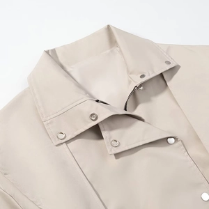 Classic beige trench coat with notched lapels and metal zipper detail in sleek finish
