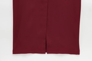 Detail of wine red dress hem with elegant slit design and precise stitching quality