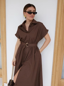Detailed view of dark brown cotton shirt dress with waist belt and side slits