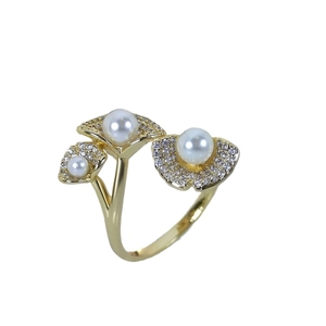 Elegant gold lotus leaf ring with pavé zircons and white pearls on white background