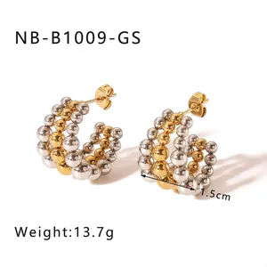 Detail of 1.5cm C-shaped earrings with gold and silver bead layers weighing 13.7g