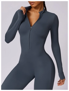 Close-up of graphite blue yoga bodysuit featuring half-zip collar and thumbhole cuffs