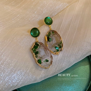 Irregular hollow earrings with emerald green stones and gold-tone finish for women