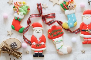 Five assorted Christmas sugar cookies with Merry Christmas text on a festive white background