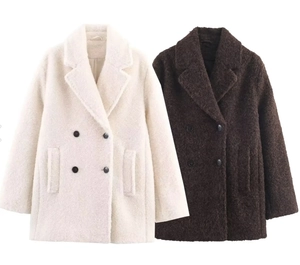 Close-up of double-breasted boucle coat with large lapels and textured faux fur fabric