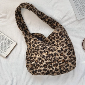 Detail view of leopard print plush tote bag with soft faux fur texture and large capacity