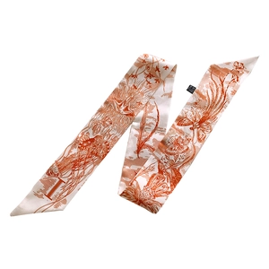 Detail of printed silk scarf with 26 letters pattern showing silk texture on white background