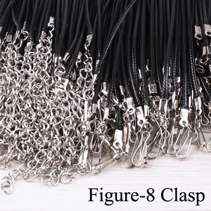 Macro detail of black waxed necklace cords with figure-8 clasps and silver extension chains