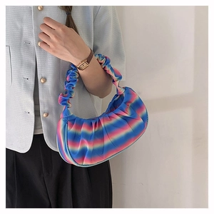 Detail showing blue and pink gradient pleated shoulder bag with a scrunchie handle