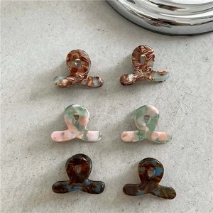 Set of 6 small acetate claw clips with assorted marble patterns for women's hair styling