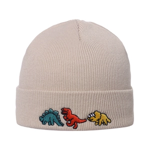 Close-up of beige beanie featuring three colorful dinosaur embroidery on ribbed knit fabric