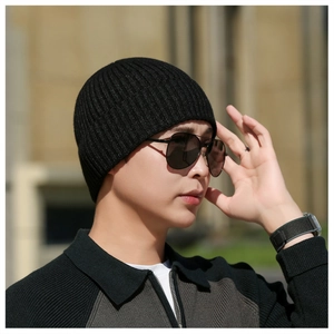 Close-up of black ribbed knit beanie with vertical striped texture and premium thermal fabric