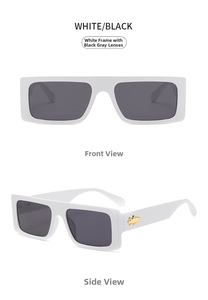 Detail of white oversized sunglasses featuring gold pig metal accents on temple