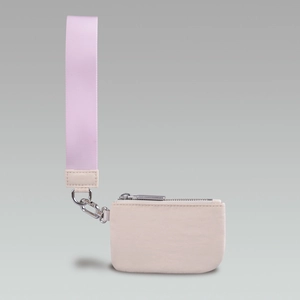 Detail of beige nylon wristlet pouch with silver zipper and pink fabric strap handle