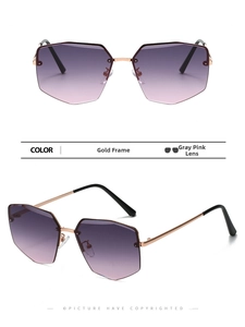 Detail of rimless polygon sunglasses with gold metal frame and gradient pink lenses