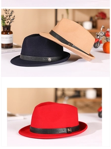 Detail of wool felt jazz hats featuring black leather bands and metallic M accents