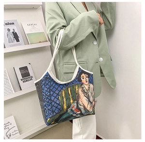 Artistic oil painting canvas tote bag worn by a model in a minimalist studio setting