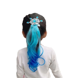 Detail of blue gradient wavy wig with a silver snowflake hair clip for girls