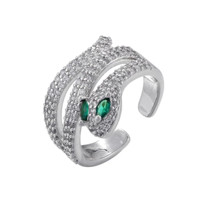Macro detail of silver snake ring with white crystals and green marquise gemstone eyes