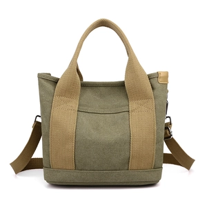 Durable army green canvas tote bag with khaki straps and adjustable shoulder strap