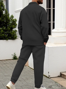 Detail of men's slim fit black waffle texture jacket showing rear view and fabric quality