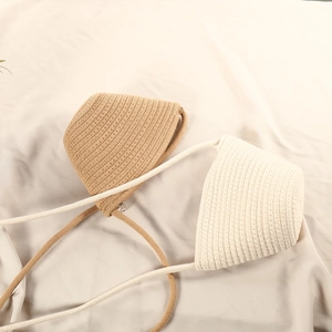 Detailed texture of cotton woven mini crossbody bags in khaki and cream white tones