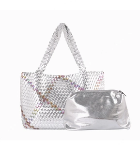 Close-up of silver woven tote and matching smooth zipper pouch with metallic finish