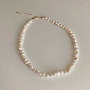 Detail of freshwater baroque pearl necklace with adjustable gold-tone lobster clasp closure