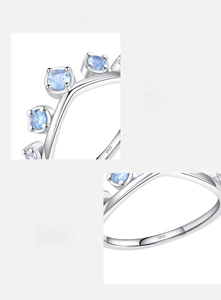Close-up of S925 sterling silver crown ring with hand-set blue zircon and hallmark