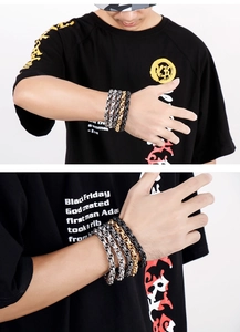 Detailed view of men's stainless steel chain bracelets in silver, gold, and black colors