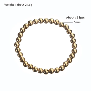 Detailed macro view of 6mm golden beaded stainless steel bracelet with 35 beads
