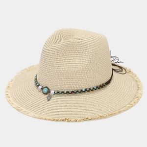 Detail of straw fedora with turquoise beads, leaf charms, and frayed brim edge