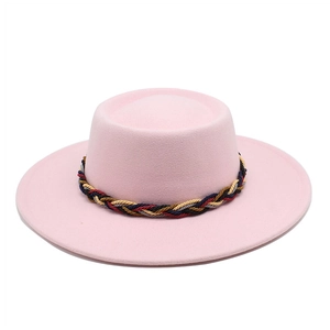 Detailed texture of pink wool felt boater hat with a colorful woven decorative band