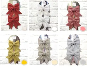 Detail shot of multi-colored glitter Christmas bows in six festive shades for tree decor