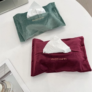 Detail of velvet tissue cover with gold Happiness embroidery in green and burgundy